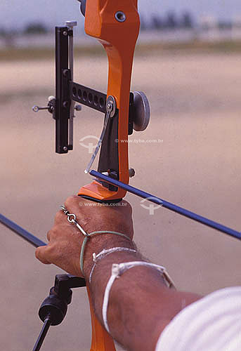  Detalhe de mão segurando arco e flecha 
