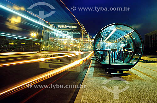  Ônibus passando em velocidade - Pessoas esperando ônibus na estação Tubo para ônibus urbanos em Curitiba - Paraná - Novembro 2000  - Curitiba - Paraná - Brasil