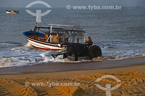  Trator puxando barco de pesca para a areia na Praia de Farol de São Thomé - Pescadores utilizam tratores para puxar e empurrar as embarcações do mar para a areia por não possuírem porto para o atracamento dos barcos  - Campos dos Goytacazes - Rio de Janeiro - Brasil
