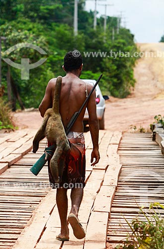  Assunto: Homem carregando animal abatido durante a caça / Local: Amazonas (AM) - Brasil / Data: 10/2013 