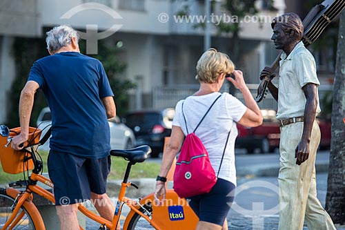  Pedestres próximo à estátua do maestro Tom Jobim no calçadão da Praia do Arpoador  - Rio de Janeiro - Rio de Janeiro (RJ) - Brasil