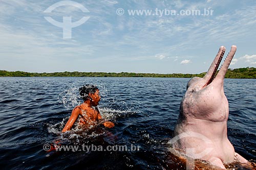  Criança brincando com Boto-cor-de-rosa (Inia geoffrensis) no Rio Negro  - Manaus - Amazonas (AM) - Brasil