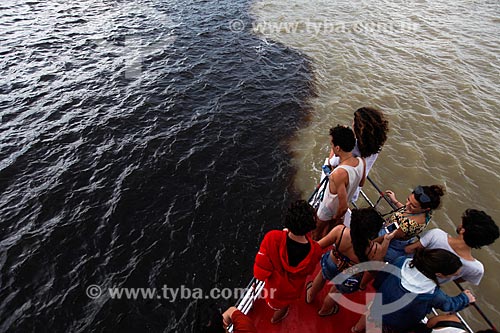  Pessoas observando o encontro das águas do Rio Negro e Rio Solimões a partir da proa do barco  - Manaus - Amazonas (AM) - Brasil