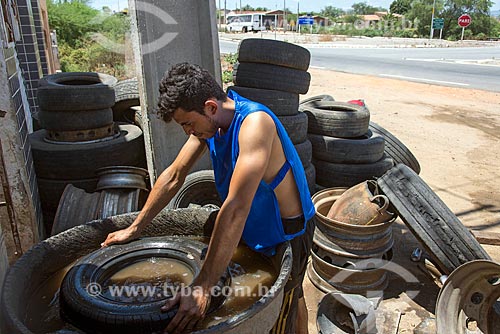  Borracheiro procurando furo em pneu de carro  - Floresta - Pernambuco (PE) - Brasil