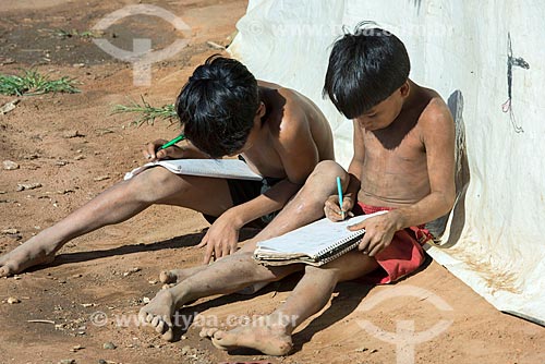  Meninos indígenas na aldeia Aiha da tribo Kalapalo interagindo com caderno escolar - ACRÉSCIMO DE 100% SOBRE O VALOR DE TABELA  - Querência - Mato Grosso (MT) - Brasil