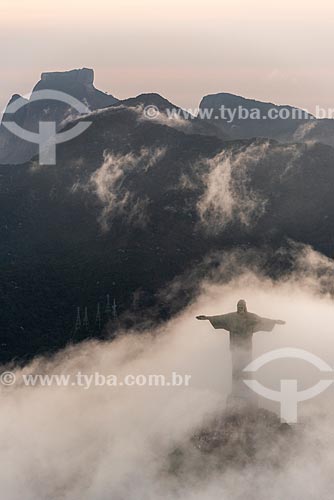  Foto aérea do Cristo Redentor com a Pedra da Gávea ao fundo durante o pôr do sol com nevoeiro  - Rio de Janeiro - Rio de Janeiro (RJ) - Brasil