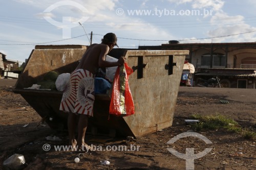 Homem catando resto de lixo em caçamba de ferro - Iranduba - Amazonas (AM) - Brasil