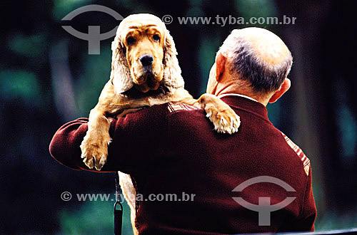  Old man holding a dog 