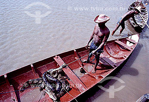  Man with snakes on a boat 