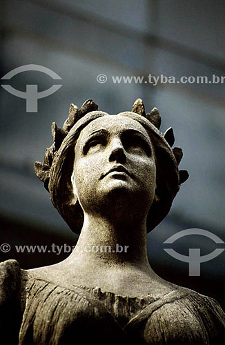  Architectural detail,  woman sculpted in stone in the roman-style, in front of the 