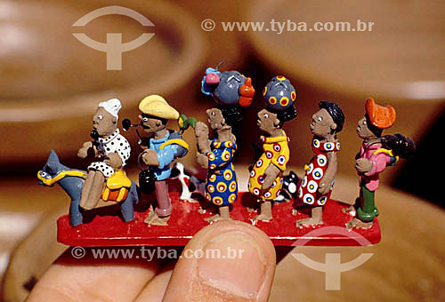  Handmade ceramics - craftwork - Hand holding  ceramic figures of 