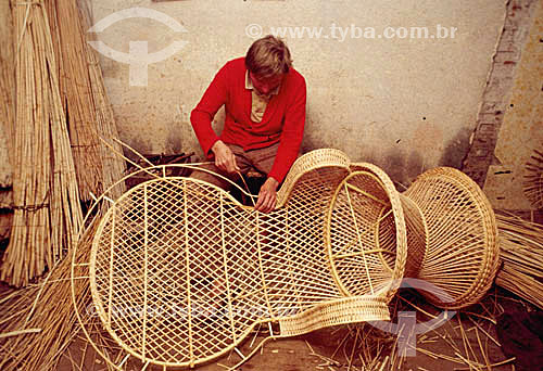  Straw Craftwork - Craftsman working on a chair made of wicker - Brazil 