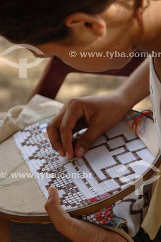  Women hands doing  an embroidery table cloth - Ferro Island - Sao Francisco River  - Pao de Acucar city - Brazil