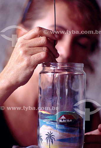  Craftwork - sand art - Woman drawing with colored sand in bottle  - Brazil