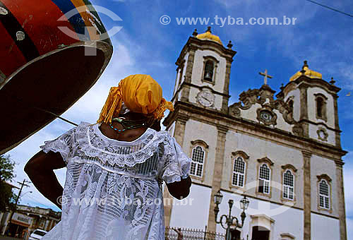  Bahian woman talking on the public phone in front of 