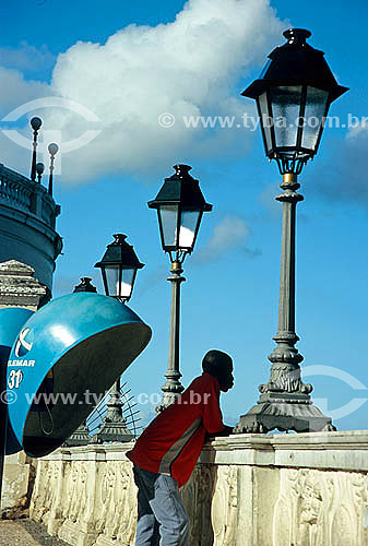  Man looking the sight next to a public phone in Salvador city - Bahia state - Brazil -  2004 