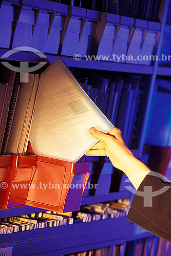  Hands of an executive woman holding a document in the file arquive 