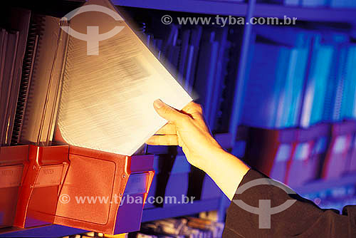  Hands of an executive woman holding a document in the file arquive 