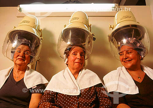  Beauty salon - three women at the hairdrier 