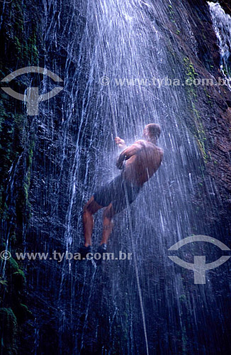  Man practicing waterfall rappel 