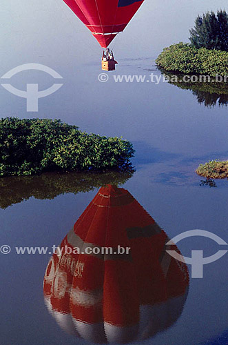  Ballooning - A red balloon and its reflection in the water 