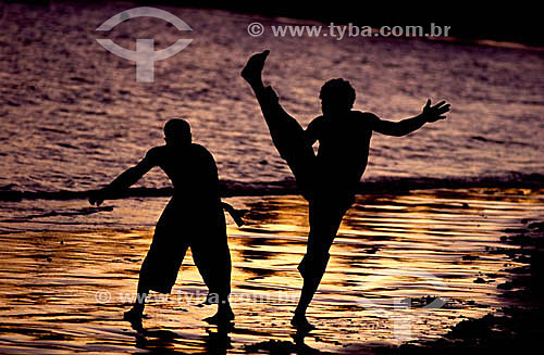  Silhouette of boys performing the Capoeira fight* in the beach - Brazil *african origin - Brazil 