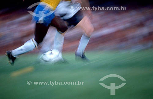  Soccer game - Brazilian Soccer Team: detail of the legs of the players kicking the ball 