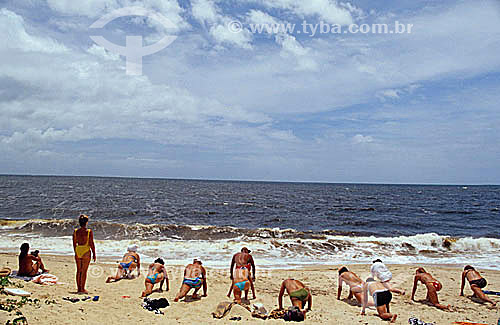  People doing gymnastics at the beach - stretching class 