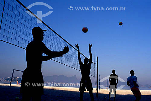  Sport - silhouette of men playing volleyball at the beach 