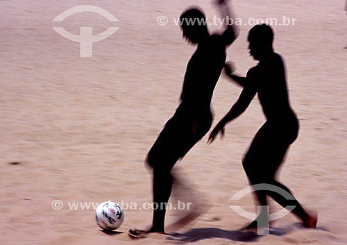  Leisure - men playing soccer game on the beach 