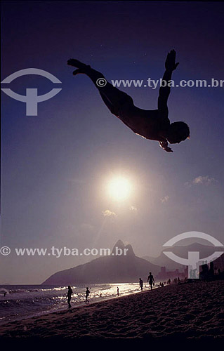  Silhouette of a man jumping - acrobatic - Ipanema Beach with the Morro Dois Irmaos (Two Brothers Hill) - Rio de Janeiro city - Rio de Janeiro state - Brazil 