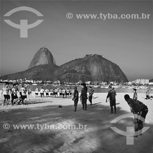  Sugar Loaf Mountain* with people playing football (in the first plan) at  the Botafogo Beach - Rio de Janeiro city - Rio de Janeiro state - Brazil  * Commonly called Sugar Loaf Mountain, the entire rock formation also includes Urca Mountain and Suga 