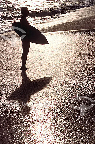  Silhouette of surfer holding board - Itacoatiara Beach - Niteroi city - Rio de Janeiro state - Brazil 