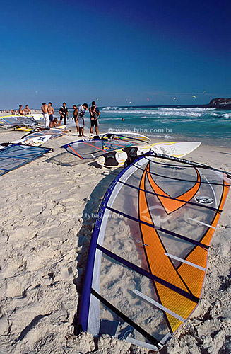  Board of windsurf on the sand with surfers in the background - Barra da Tijuca Beach - Rio de Janeiro city - Rio de Janeiro state - Brazil 