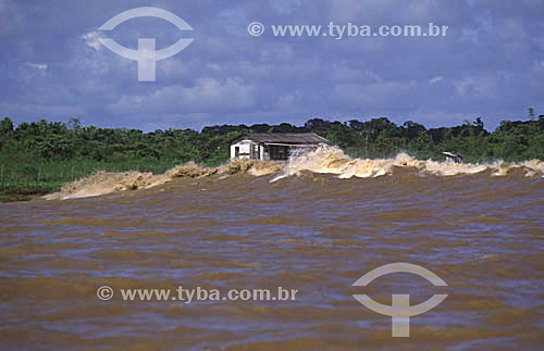  A *pororoca and a small hut on the Araguari River - Amapa state - Brazil  *A pororoca is a natural phenomenon occuring at the meeting point between a river and a sea, creating incredibly rough water. 