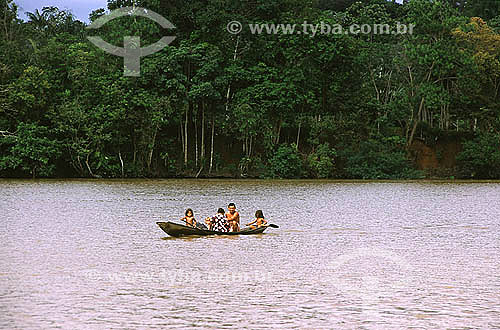  Family in a canoe in Matupi river, that divide Mazagao and Santana county - Amapa state - Brazil 