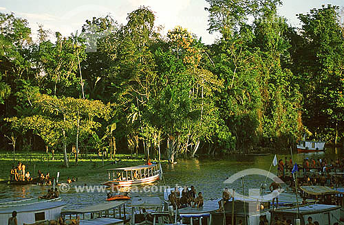  People in the river between boats during the St. James festival at Mazagao village - Amapa state - Brazil 