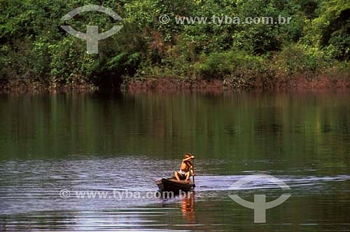  Boy crossing RIo Negro river in small boat - Amazonas state - Brazil 