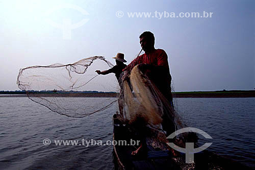  Fishermen casting a fishing net in Mamiraua Lake - Amazonas state - Brazil 