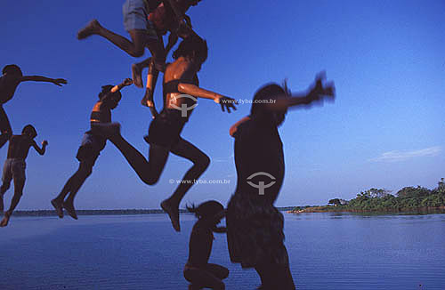  Amazonian  Inhabitants - Children playing of jumping on Rio Negro - Amazonas state - Brazil 