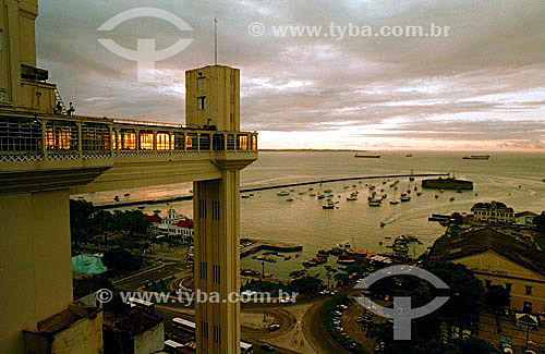  Sunset in Salvador historical city: Elevador Lacerda (Lacerda Elevator) to the left with Mercado Modelo below to the right and Forte São Marcelo (Sao Marcelo Fort) (1) with boats around on Baía de Todos os Santos (All Saints Bay) in the background - 
