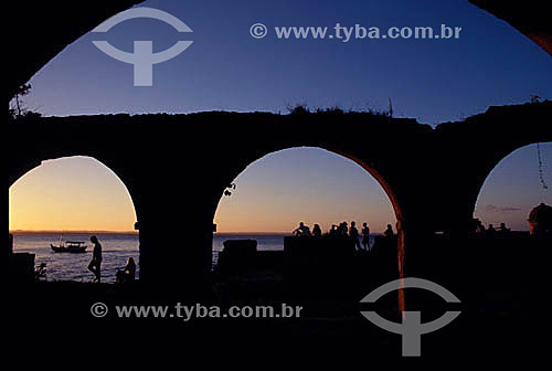  Silhouette of people behind the Ruins of the Fort - Morro de Sao Paulo (Sao Paulo Hill) at sunset - 