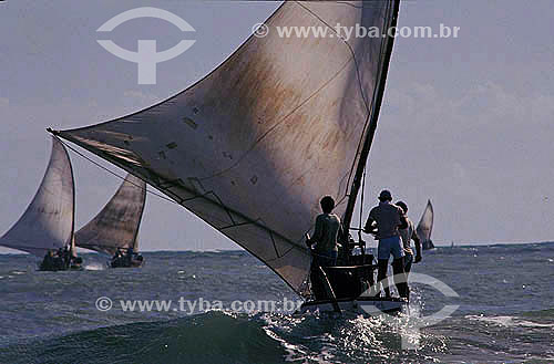  Men sailing rafts at Caponga beach - Ceara state coast - Brazil 