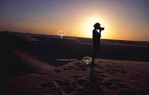  Woman taking pictures on dunes in 