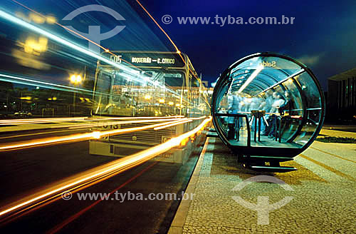  Bus passing in high speed - People waiting in the Tube bus stop for urban transport - Curitiba city - Parana state - Brazil - November 2000 