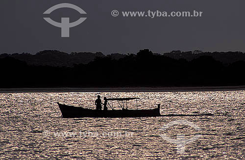  Couple silhouette in a boat at sunset - Superagui Island - Parana state - Brazil 