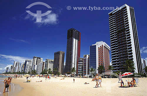  People at the sand of Boa Viagem beach with buildings in the background - Recife city - Pernambuco state - Brazil 