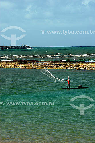  Fisherman throwing a net in the sea at Muro alto city - Pernambuco state coast - Brazil 