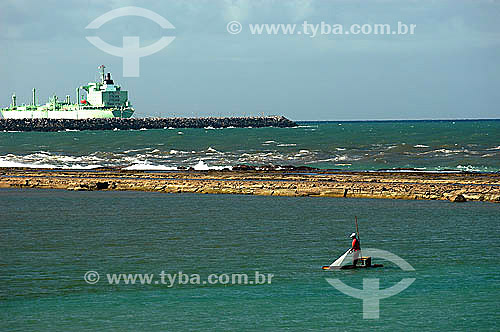  Fisherman in the foreground and a ship in the background - Muro Alto city - Pernambuco state coast - Brazil 