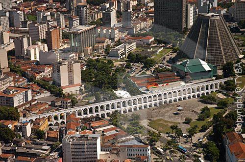  Aerial view of  Rio de Janeiro city downtown, showing the conical São Sebastião do Rio de Janeiro`s Cathedral (or Metropolitan Cathedral) at the right, and the 